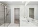 Modern bathroom featuring double sinks, sleek countertops, a glass-enclosed shower, and a large mirror at 1466 31St Ne St, Conover, NC 28613