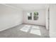 Bright bedroom featuring plush carpeting and two windows overlooking a treed landscape at 1466 31St Ne St, Conover, NC 28613