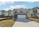 Charming two-story home featuring a two-car garage, brick accents, and blue shutters at 1466 31St Ne St, Conover, NC 28613