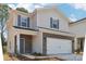 Charming two-story home featuring a two-car garage, brick accents, and blue shutters at 1466 31St Ne St, Conover, NC 28613