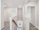 Bright hallway and stairway featuring neutral carpeting, white walls, and natural light, creating a welcoming transition at 1466 31St Ne St, Conover, NC 28613