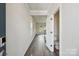 Inviting hallway with wood floors, leading to a bright living area and powder room at 1466 31St Ne St, Conover, NC 28613