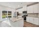 Modern kitchen island featuring granite countertops, a sink, and stylish cabinetry, complemented by stainless steel appliances at 1466 31St Ne St, Conover, NC 28613
