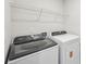 Modern laundry room with washer, dryer, and overhead wire shelving at 1466 31St Ne St, Conover, NC 28613