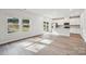 Bright living space featuring light wood floors, two windows, and sliding glass door, adjacent to a modern kitchen at 1466 31St Ne St, Conover, NC 28613