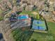 Aerial shot of community pool and tennis courts, surrounded by lush landscaping and nearby homes at 1624 Chadmore Nw Ln, Concord, NC 28027