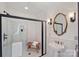 Bathroom featuring a glass enclosed shower, pedestal sink, and a wall mirror at 1624 Chadmore Nw Ln, Concord, NC 28027