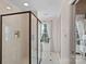 This bathroom features a glass enclosed shower with tile surround and flooring, a window with decorative curtains, and neutral walls at 1624 Chadmore Nw Ln, Concord, NC 28027