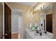 Charming bathroom with floral wallpaper, double vanity, and wood accents offers a cozy and inviting space at 1624 Chadmore Nw Ln, Concord, NC 28027