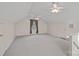Expansive bonus room with neutral carpet, multiple ceiling fans, and plenty of natural light at 1624 Chadmore Nw Ln, Concord, NC 28027