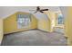 Spacious bonus room with gray carpet, built-in seat under the window, yellow painted walls and ceiling fan at 1624 Chadmore Nw Ln, Concord, NC 28027