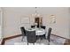 Elegant dining room with hardwood floors, round table, and stylish decor, ideal for entertaining guests at 1624 Chadmore Nw Ln, Concord, NC 28027