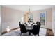 Bright dining room featuring natural light, hardwood floors, round table with seating for six, and soft wallpaper at 1624 Chadmore Nw Ln, Concord, NC 28027