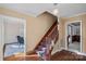 Inviting foyer with hardwood floors, staircase with runner, and elegant lighting fixture at 1624 Chadmore Nw Ln, Concord, NC 28027