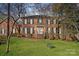 Charming two-story brick home with lush green lawn and mature trees, a welcoming facade with a double door entrance at 1624 Chadmore Nw Ln, Concord, NC 28027