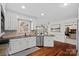 Bright kitchen features stainless appliances, tile backsplash, white cabinets, and hardwood floors at 1624 Chadmore Nw Ln, Concord, NC 28027