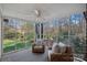 A screened-in porch features ample seating for enjoying the backyard at 1624 Chadmore Nw Ln, Concord, NC 28027