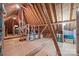Spacious unfinished attic with wooden beams offering ample storage and potential for customization at 16624 Flying Jib Rd, Cornelius, NC 28031