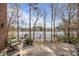 Enjoy breathtaking lake views from this spacious outdoor balcony with comfortable seating at 16624 Flying Jib Rd, Cornelius, NC 28031