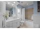 Charming bathroom with blue walls, a window above the tub, and white vanity with storage at 16624 Flying Jib Rd, Cornelius, NC 28031