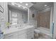 Clean bathroom with white cabinets, tile floors, and a tub/shower combo with tiled wall at 16624 Flying Jib Rd, Cornelius, NC 28031