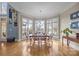 Bright dining room with beautiful lake view, hardwood floors, and elegant chandelier at 16624 Flying Jib Rd, Cornelius, NC 28031
