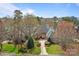 Beautiful waterfront home boasts manicured landscaping, mature trees, and a private driveway at 16624 Flying Jib Rd, Cornelius, NC 28031