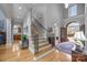 Grand foyer with hardwood floors, staircase, and arched doorway leading to another room at 16624 Flying Jib Rd, Cornelius, NC 28031