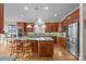 Spacious kitchen featuring granite countertops, custom cabinets, stainless steel appliances, and hardwood floors at 16624 Flying Jib Rd, Cornelius, NC 28031