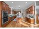 Spacious kitchen featuring stainless steel appliances, wood cabinets, and an island with barstool seating at 16624 Flying Jib Rd, Cornelius, NC 28031
