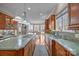 Gourmet kitchen with custom cabinetry, granite countertops, and top-of-the-line stainless steel appliances at 16624 Flying Jib Rd, Cornelius, NC 28031