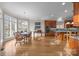Open concept kitchen and dining area featuring stainless steel appliances and a lake view at 16624 Flying Jib Rd, Cornelius, NC 28031