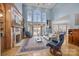 Grand living room with soaring ceilings, a fireplace, and expansive windows overlooking the lake at 16624 Flying Jib Rd, Cornelius, NC 28031