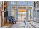 Cozy living room featuring lake views through expansive windows and a comfortable seating area at 16624 Flying Jib Rd, Cornelius, NC 28031