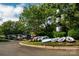 Scenic view of a marina featuring a variety of boats, lush trees, and a lighthouse at 16624 Flying Jib Rd, Cornelius, NC 28031