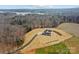 Beautiful aerial shot showing the home set on a lush green lawn, wooded privacy, and lake views at 1695 Agner Rd, Salisbury, NC 28146