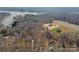 Aerial shot of new construction, featuring two story home and wooded backdrop, with lake in distance at 1695 Agner Rd, Salisbury, NC 28146