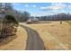 Expansive property featuring a modern farmhouse with a long, private driveway and beautifully maintained surrounding landscape at 1695 Agner Rd, Salisbury, NC 28146