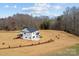 Expansive aerial view of a white two-story home with a black roof set on a large lot with mature trees at 1695 Agner Rd, Salisbury, NC 28146