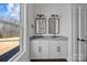 This bathroom has a dual sink vanity with granite countertop, decorative mirrors, and modern fixtures at 1695 Agner Rd, Salisbury, NC 28146