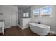 Modern bathroom showcasing a freestanding tub and a glass-enclosed shower with great natural light at 1695 Agner Rd, Salisbury, NC 28146