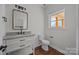 Well-lit bathroom with granite countertop, vanity, toilet, and a window offering natural light at 1695 Agner Rd, Salisbury, NC 28146