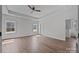 Spacious bedroom with a tray ceiling, ceiling fan, hardwood floors, and ample natural light at 1695 Agner Rd, Salisbury, NC 28146