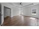 Bright bedroom with hardwood floors, two windows, tray ceiling, and neutral decor at 1695 Agner Rd, Salisbury, NC 28146