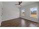 This minimalist bedroom has hardwood floors, a ceiling fan, and two windows overlooking the landscape at 1695 Agner Rd, Salisbury, NC 28146