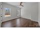 This bedroom boasts hardwood floors, a modern ceiling fan, and two large windows providing natural light at 1695 Agner Rd, Salisbury, NC 28146
