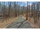 Winding gravel driveway leading through a tranquil wooded area, offering privacy and a scenic approach to the home at 1695 Agner Rd, Salisbury, NC 28146