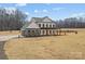 Modern farmhouse with attached two-car garage, complemented by professionally landscaped yard and inviting front porch at 1695 Agner Rd, Salisbury, NC 28146