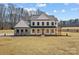 Charming two-story modern farmhouse with stone accents, a welcoming porch, and a meticulously maintained lawn at 1695 Agner Rd, Salisbury, NC 28146