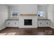 Stylish fireplace with white shiplap, wooden mantle, and built-in cabinets at 1695 Agner Rd, Salisbury, NC 28146